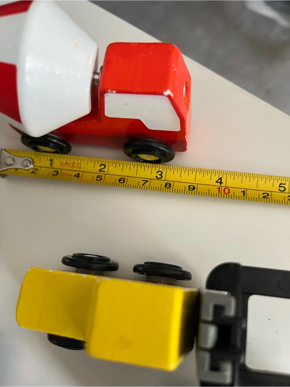 8 wooden cars and trucks.  Four are kidKraft.